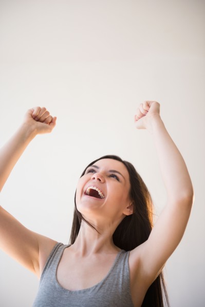 Young woman in victorious gesture