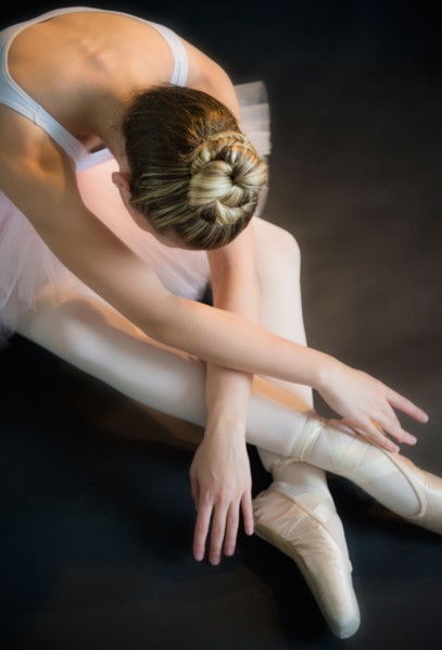 Teenage (16-17) ballerina bending over