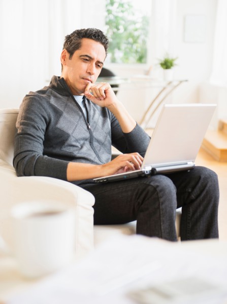 Portrait of man working on laptop at home