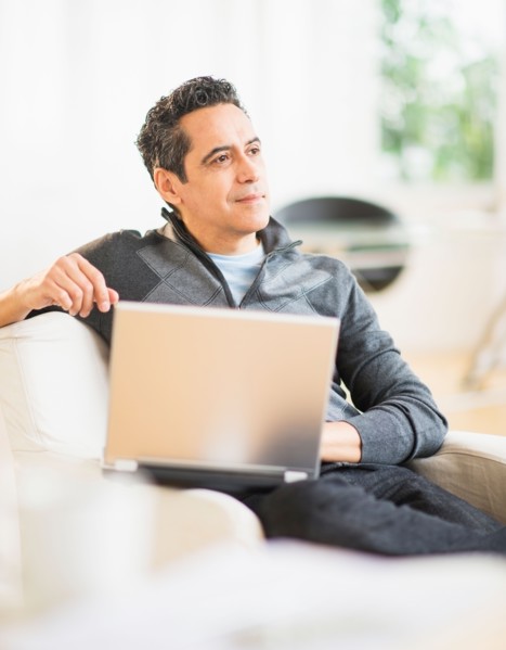Portrait of man working on laptop at home