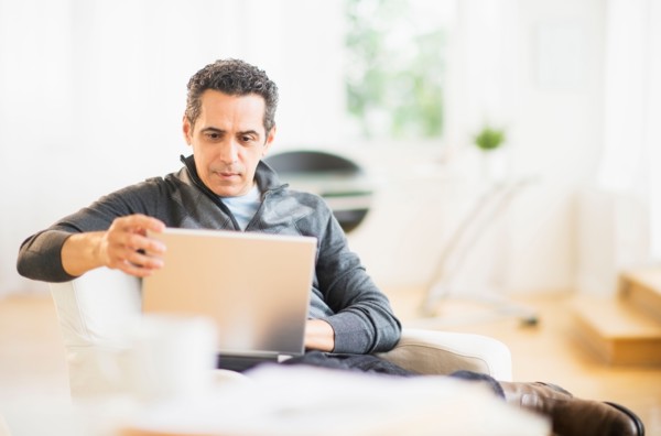 Portrait of man working on laptop at home