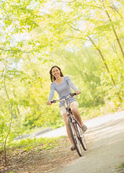 Mid adult woman riding bicycle