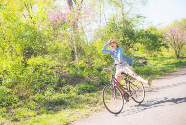 Mid adult woman riding bicycle