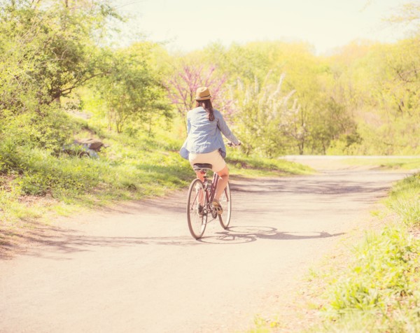 Mid adult woman riding bicycle