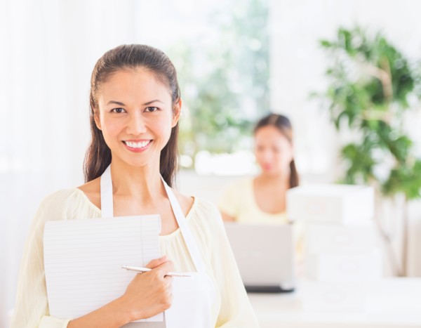 Portrait of mid adult women holding document