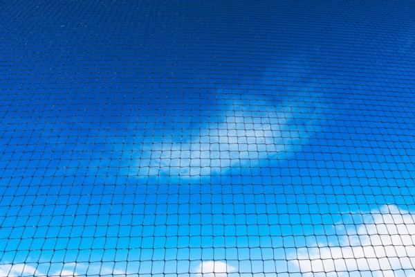 Grid-wire fence against sky