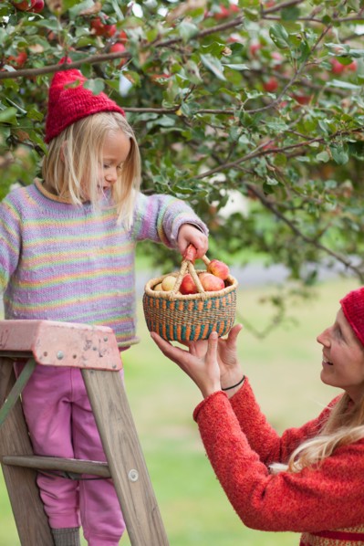 Mother and daughter picking up apples