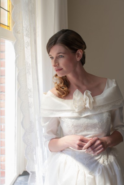 Bride looking out window