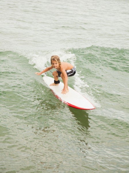 Boy (6-7) surfing