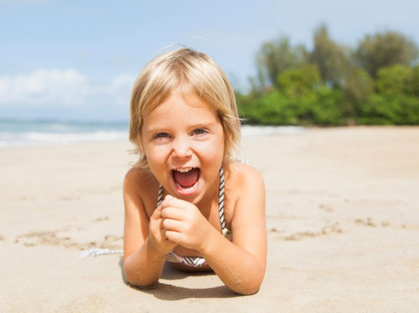 Happy girl (2-3) on sandy beach