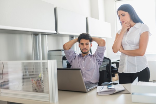 Business man and woman at work in office.