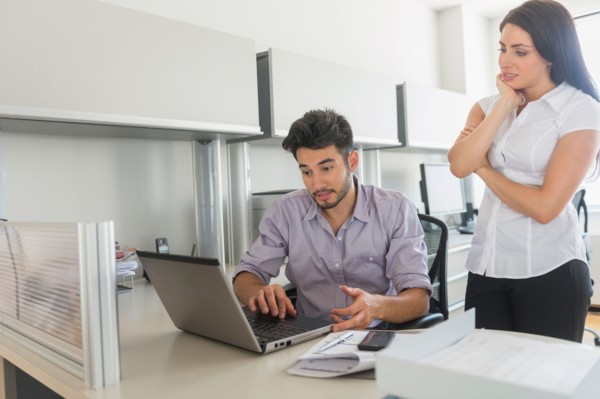 Business man and woman at work in office.