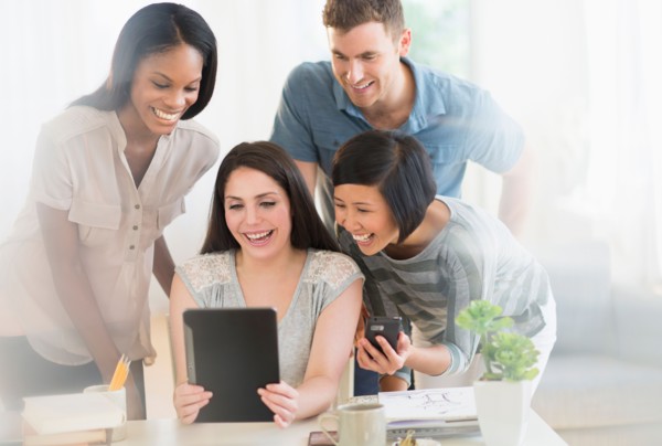 Group of young friends using digital tablet.