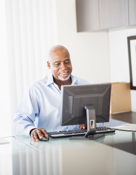 Portrait of senior man working on computer in office
