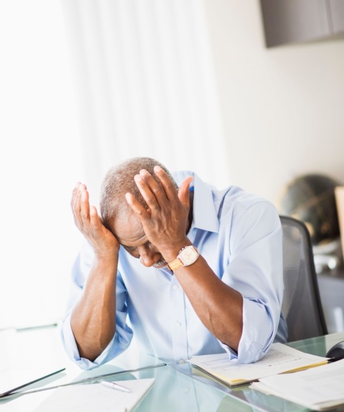 Portrait of tired senior man in office