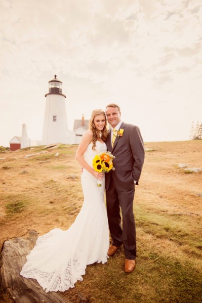 Portrait of married couple, lighthouse in background