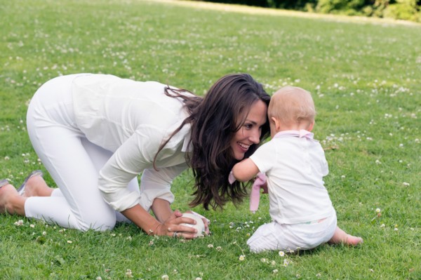 Mother and daughter (12-17 months) playing in park