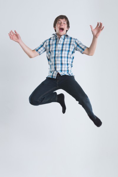 Studio Shot of teenage boy (14-15) jumping