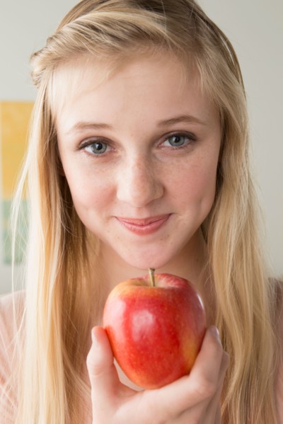 Girl (14-15) holding apple