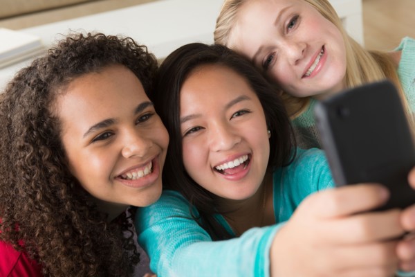 Girls (12-13,14-15,16-17) playing with smartphone