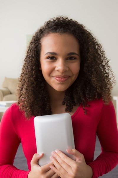 Portrait of girl (12-13) with digital tablet