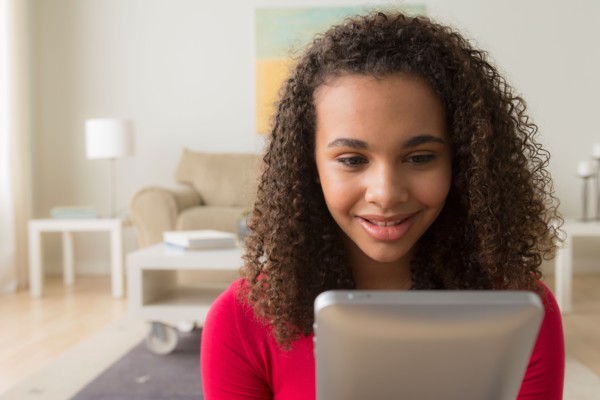 Portrait of girl (12-13) with digital tablet