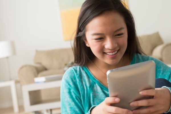Portrait of teenage girl (16-17) with digital tablet