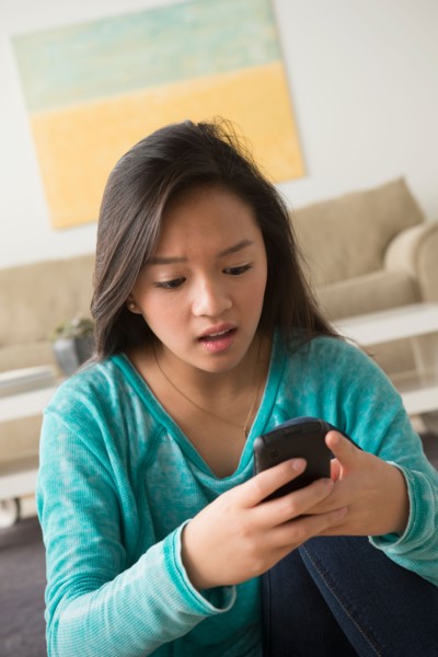 Portrait of teenage girl (16-17) with smartphone
