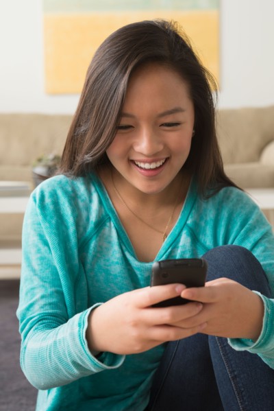 Portrait of teenage girl (16-17) with smartphone