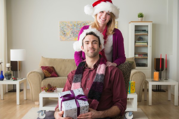Portrait of young couple wearing santa hats