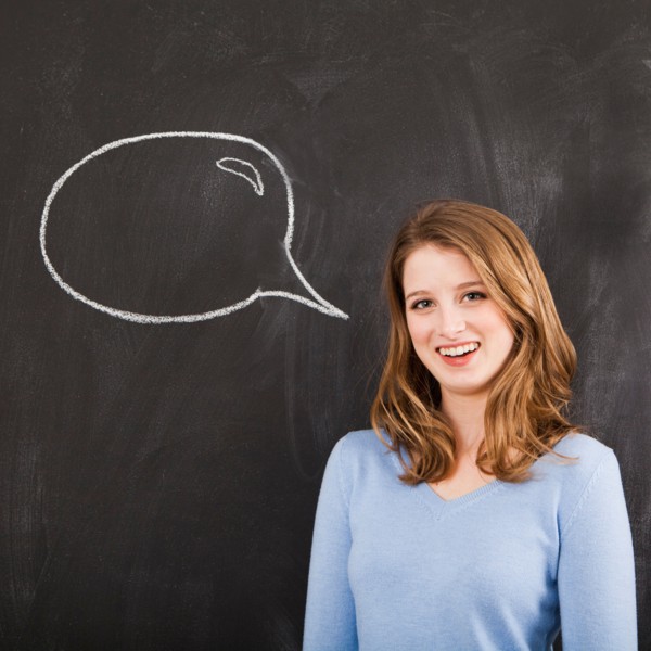 Studio portrait of woman with chalk speech bubble