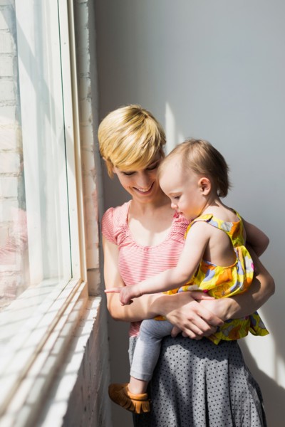 Mother holding daughter (12-17 months)