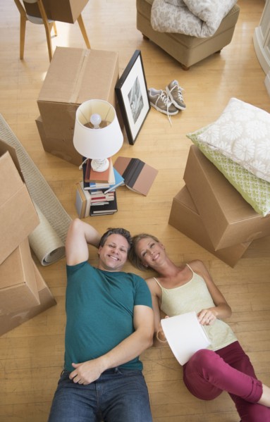Couple lying on floor of new home.