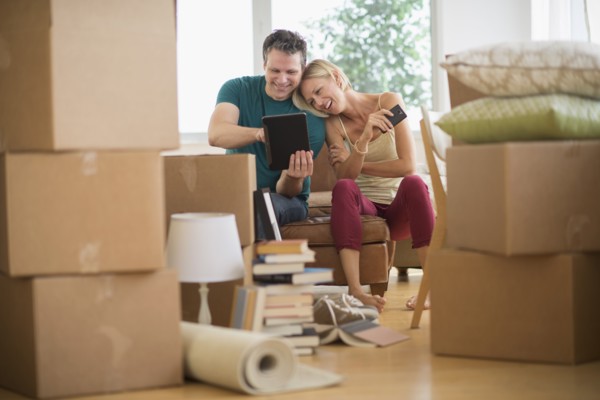 Couple using tablet pc in new home.