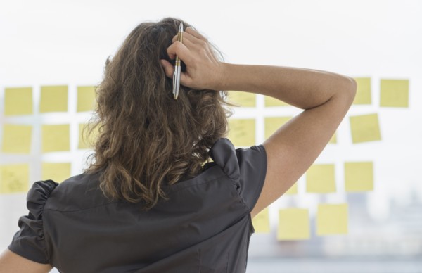 Business woman arranging yellow notes.