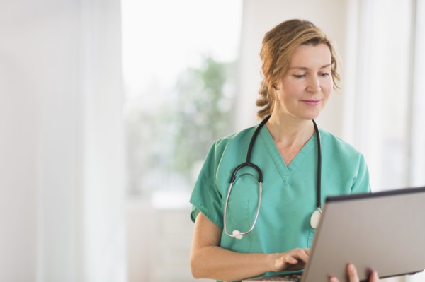 Female doctor using laptop.