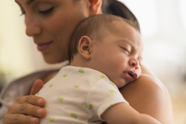 Mother holding baby (2-5 months).