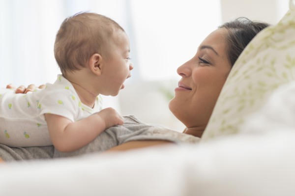 Mother playing with baby boy (2-5 months).
