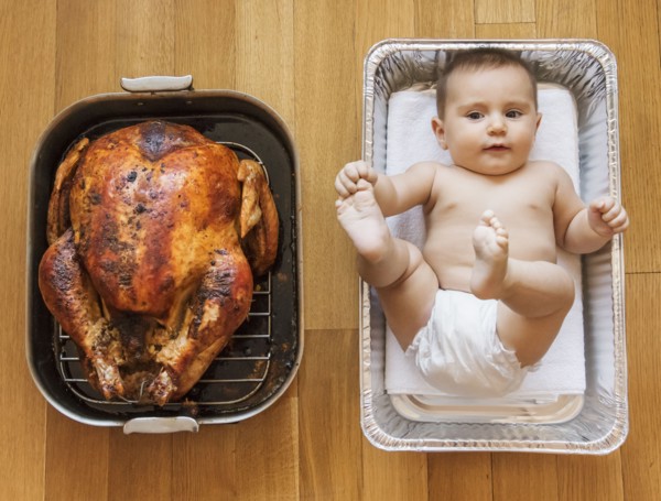 Baked turkey and baby girl (2-5 months) in baking dish.