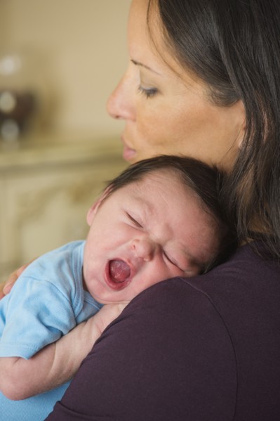 Portrait of mother holding newborn baby (0-11 months).
