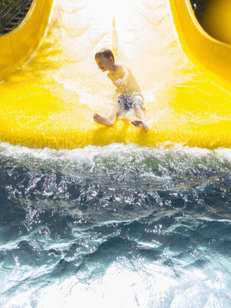 Boy (6-7) having fun on water slide. Germany, Thuringia.
Photo : JOHANNES KROEMER