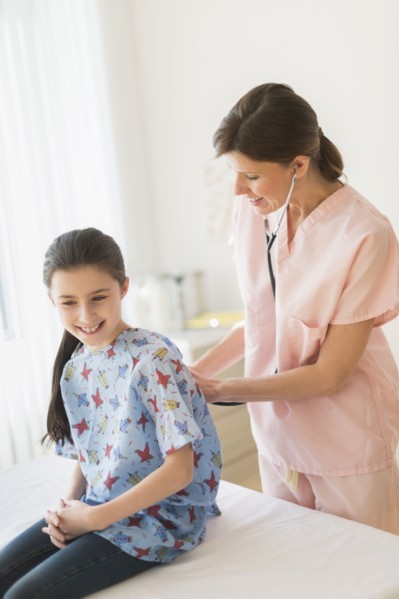 Doctor examining girl (8-9).