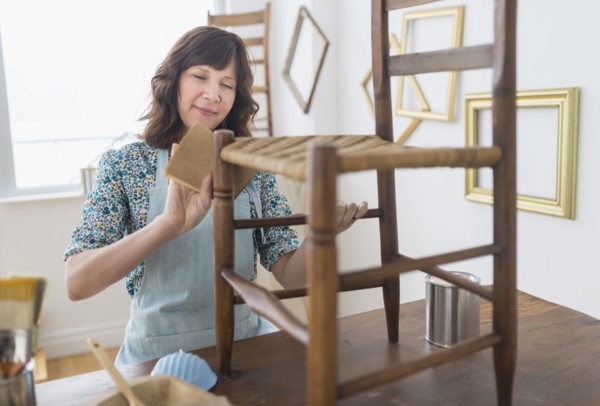Woman restoring antique furniture.