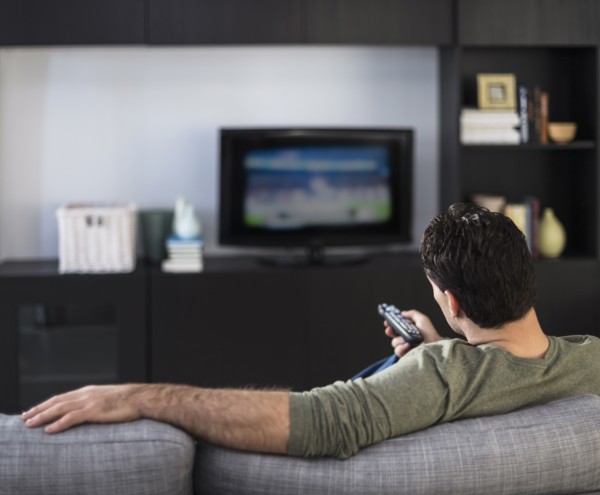 Rear view of man watching tv.