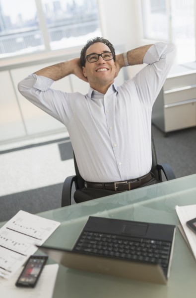 Businessman using laptop and digital tablet.
