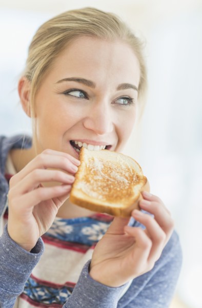 Woman eating toast.
