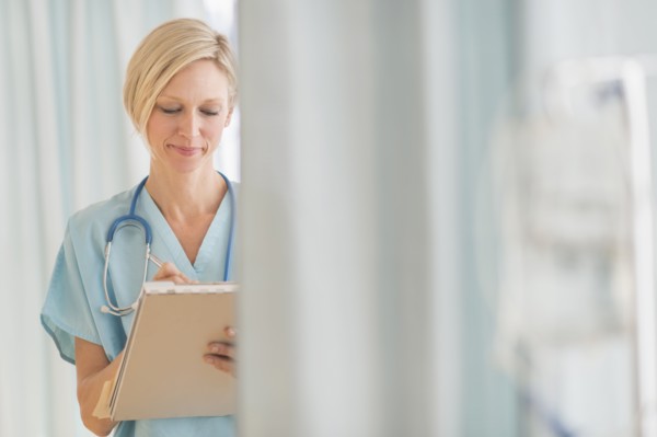 Female doctor doing notes.