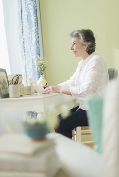Mature woman writing letter.