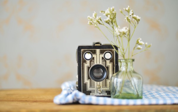 Studio shot of vintage camera and flowers.
