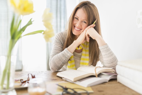 Portrait of smiling woman sitting at desk.